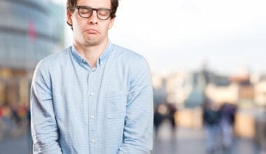 A relaxed young man expressing a sense of indifference and patience