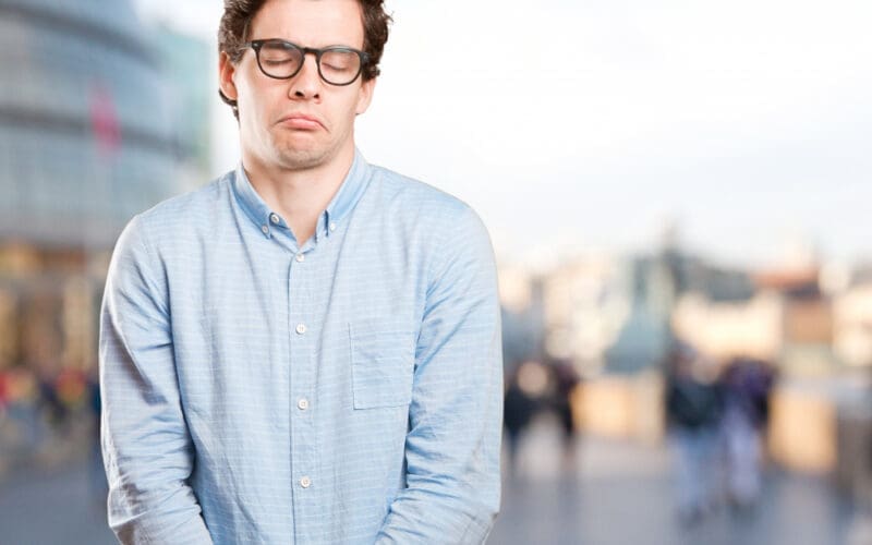 A relaxed young man expressing a sense of indifference and patience