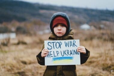 A sad boy pleads for an end to the war between Russia and Ukraine