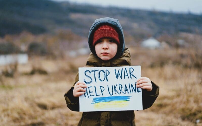 A sad boy pleads for an end to the war between Russia and Ukraine