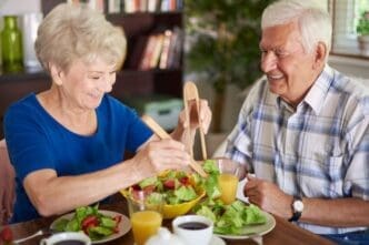 A smiling senior couple enjoying a healthy breakfast