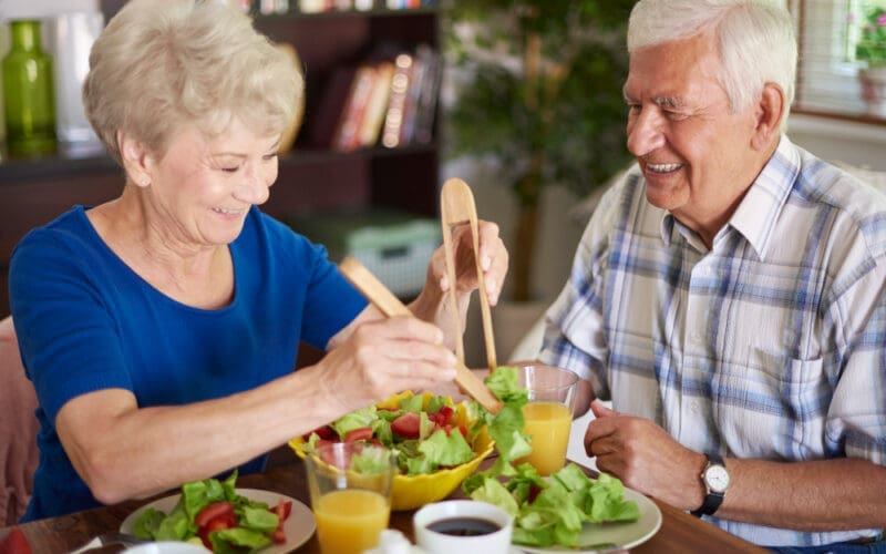 A smiling senior couple enjoying a healthy breakfast