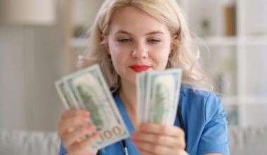 A thrilled woman counting her dollar bills, symbolizing financial success