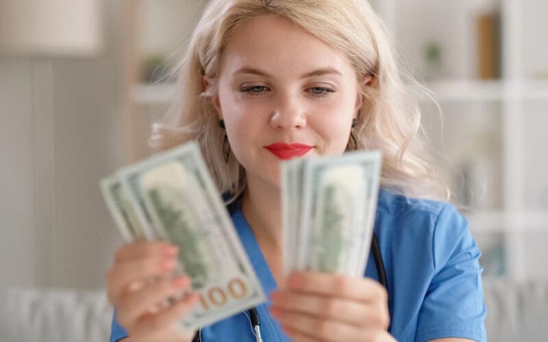A thrilled woman counting her dollar bills, symbolizing financial success