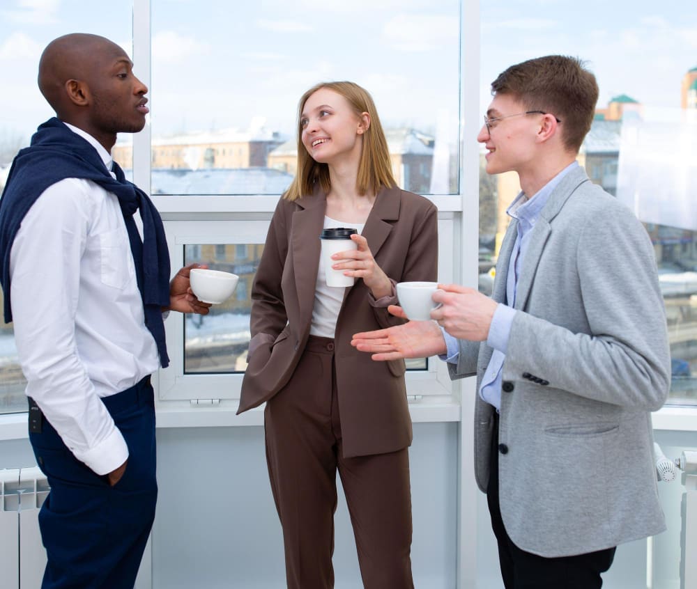 A woman and two men are conversing while effectively using their personal space