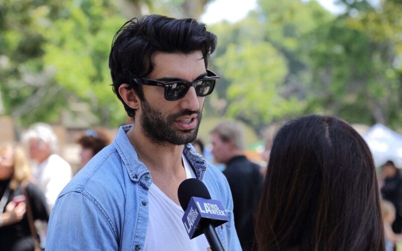 Actor Justin Baldoni talks to a reporter at the “Rocket’s Universe” grand opening, which is the 64th universally accessible playground built by Shane’s Inspiration