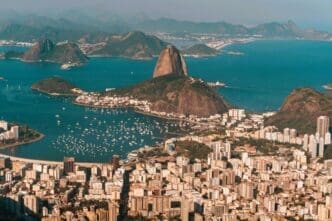 Aerial view of Rio de Janeiro, bathed in sunlight, nestled between the sea and hills in Brazil
