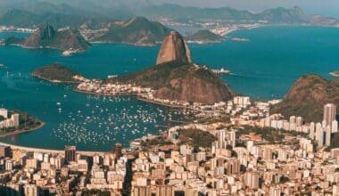 Aerial view of Rio de Janeiro, bathed in sunlight, nestled between the sea and hills in Brazil