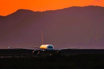 Airplane against sky during sunset