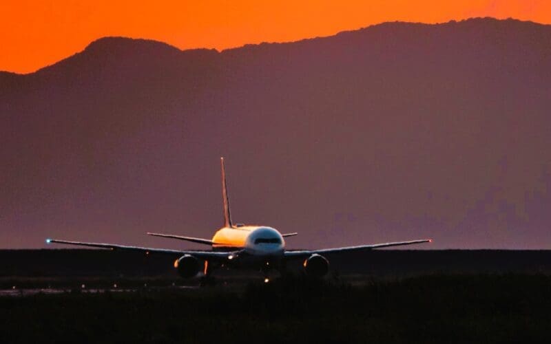 Airplane against sky during sunset