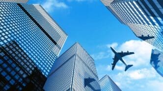 Airplane flying over building at Central Business District