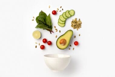 Artistic arrangement of salad ingredients in a ceramic bowl
