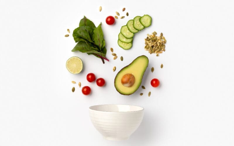 Artistic arrangement of salad ingredients in a ceramic bowl