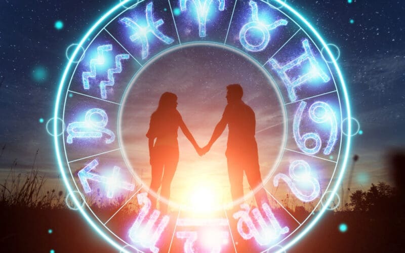 Astrological theme featuring a couple, a man and a woman, set against a backdrop of a circle adorned with zodiac signs