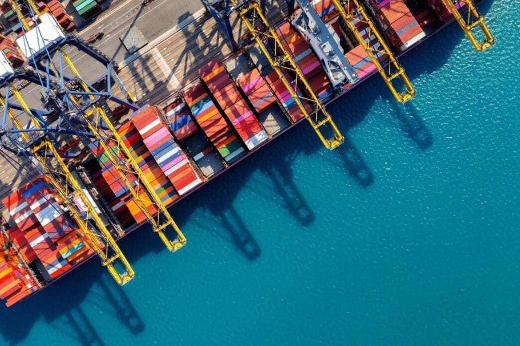 Bird's-eye view of a cargo ship and containers in the harbor