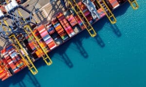 Bird's-eye view of a cargo ship and containers in the harbor