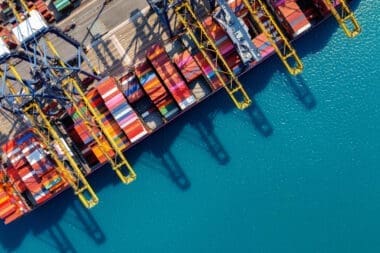 Bird's-eye view of a cargo ship and containers in the harbor