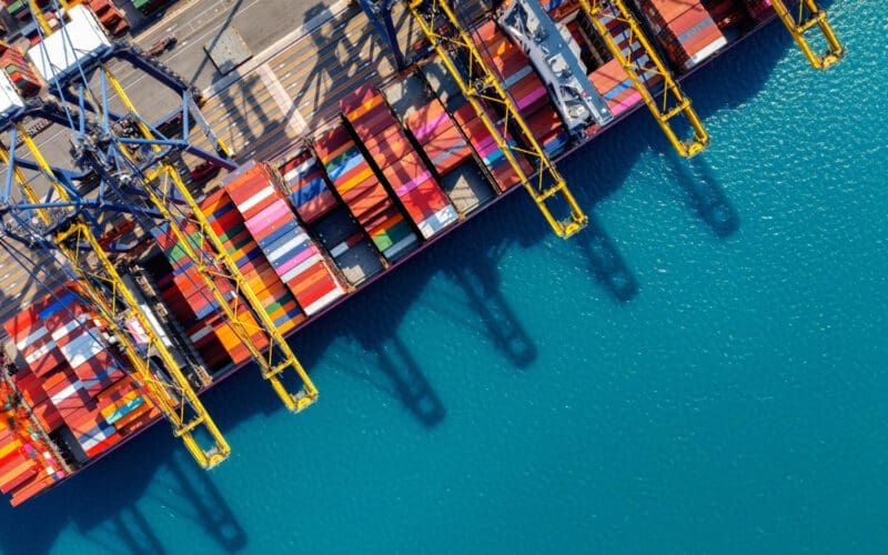 Bird's-eye view of a cargo ship and containers in the harbor