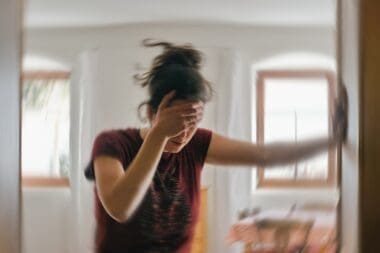 Blured photo of a woman suffering from vertigo or dizziness or other health problem of brain or inner ear