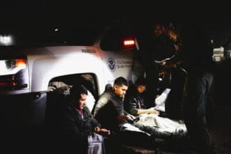 Border Patrol agents take three migrant men, a Mexican, a Guatemalan and a Honduran, who illegally crossed the Rio Grande River to enter the U.S. into custody