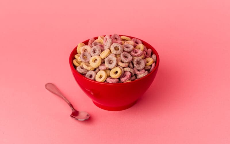 Bowl of cereal isolated on a pink background