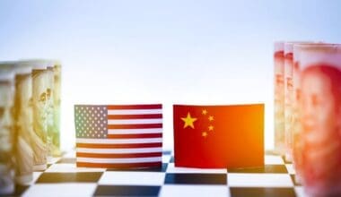 Close-up of a chessboard symbolizing the economic rivalry between the USA and China, featuring flags and currency from both nations