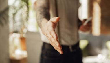 Close-up of a male hand extending in greeting, welcoming someone