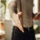 Close-up of a male hand extending in greeting, welcoming someone