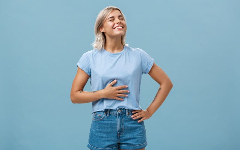 Cute girl likes eat after workout being pleased and stuffed after dinner