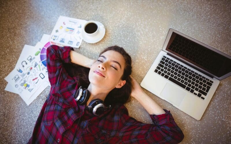 Female graphic designer lying on floor