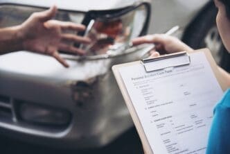 Insurance agent assisting with the on-site car accident claim process – a concept focused on people and car insurance claims