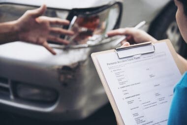 Insurance agent assisting with the on-site car accident claim process – a concept focused on people and car insurance claims