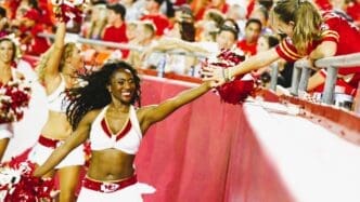 Krystal Anderson high fives fan during a Chiefs game