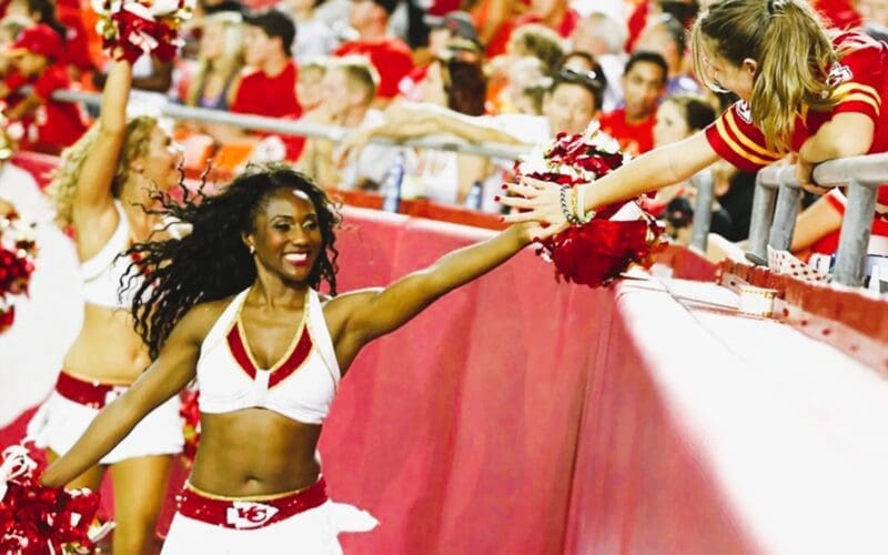 Krystal Anderson high fives fan during a Chiefs game