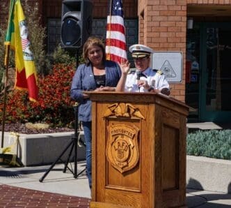LA Fire Chief Kristin Crowley speaks at Station 112 on Fire Service Day, joined at the podium by Yolanda Regalado, recipient of the Honorary Fire Chief award