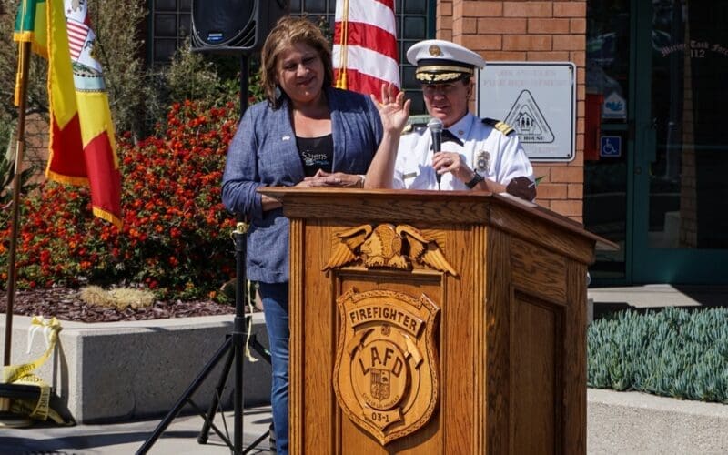 LA Fire Chief Kristin Crowley speaks at Station 112 on Fire Service Day, joined at the podium by Yolanda Regalado, recipient of the Honorary Fire Chief award