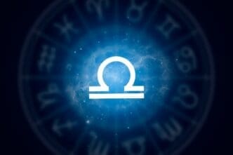 Libra zodiac sign set against a backdrop of a starry night sky