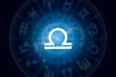 Libra zodiac sign set against a backdrop of a starry night sky