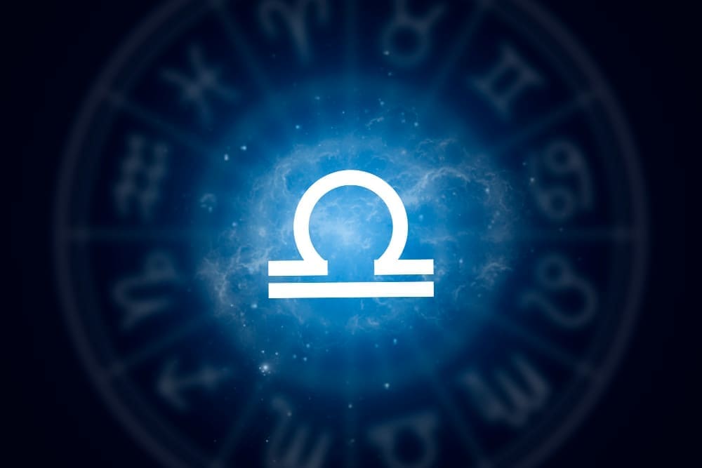 Libra zodiac sign set against a backdrop of a starry night sky