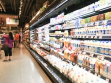 Long refrigerator filled with food at a supermarket