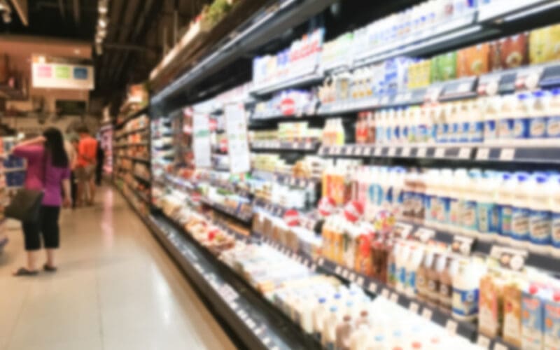 Long refrigerator filled with food at a supermarket