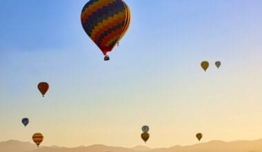 Many hot air balloons flying on the sky at sunrise in Temecula, California USA