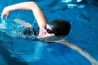 Medium shot of a female swimmer in action