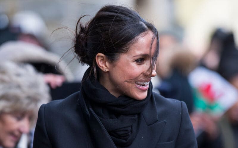 Meghan Markle arrives at a blustery Cardiff Castle