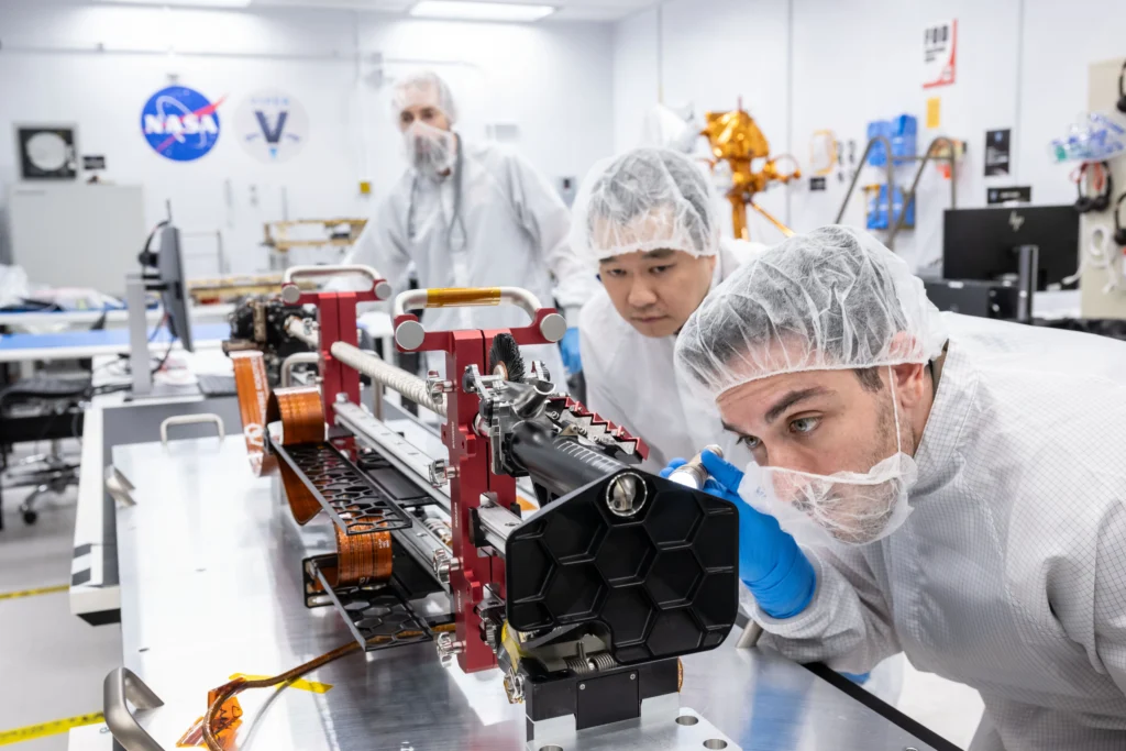 A team of engineers from NASA’s Johnson Space Center in Houston and Honeybee Robotics in Altadena, California inspect TRIDENT – short for The Regolith Ice Drill for Exploring New Terrain – shortly after its arrival at the integration and test facility. Credit: NASA/Robert Markowitz