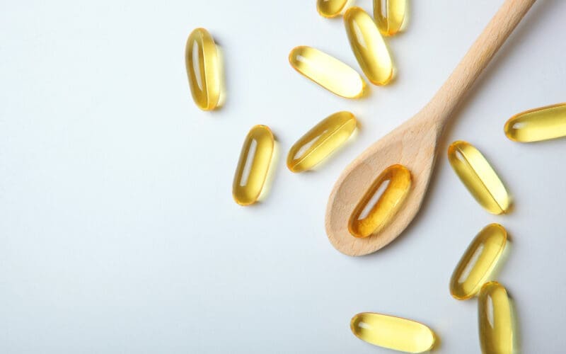 Omega capsules displayed against a gray backdrop