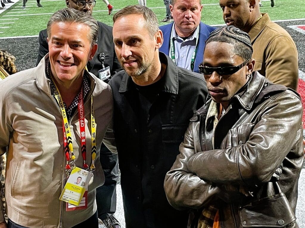 Rubin on the sideline of Mercedes-Benz Stadium with Learfield CEO Cole Gahagan and musician Travis Scott
