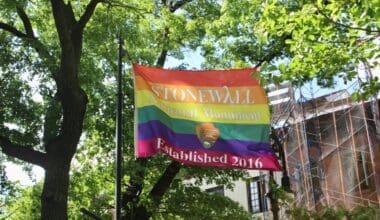 Stonewall National Monument Established 2016 rainbow flag from National Park Service flying in the park on Christopher Street in Greenwich Village, New York Cit