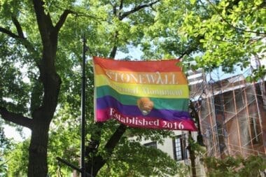 Stonewall National Monument Established 2016 rainbow flag from National Park Service flying in the park on Christopher Street in Greenwich Village, New York Cit
