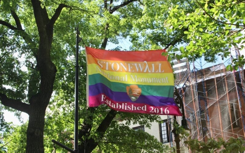 Stonewall National Monument Established 2016 rainbow flag from National Park Service flying in the park on Christopher Street in Greenwich Village, New York Cit